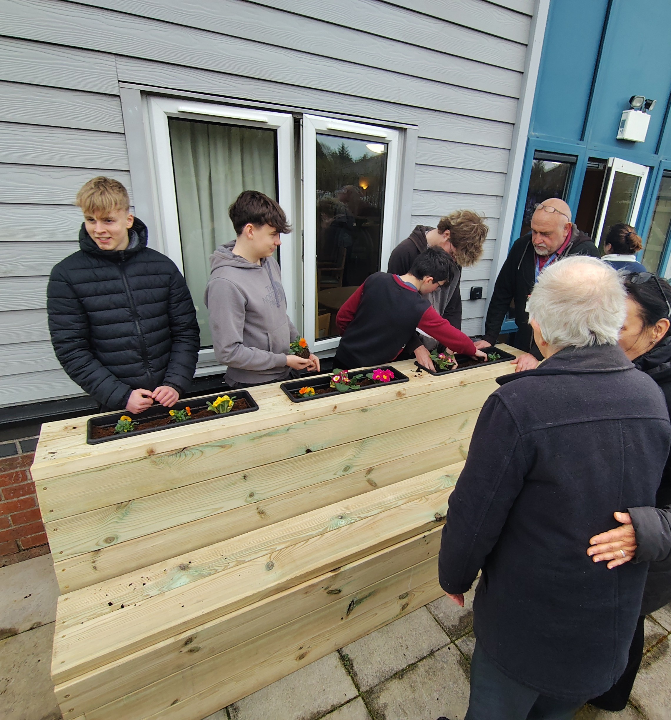 Hafan y Waun residents celebrate new accessible garden furniture crafted by local learners