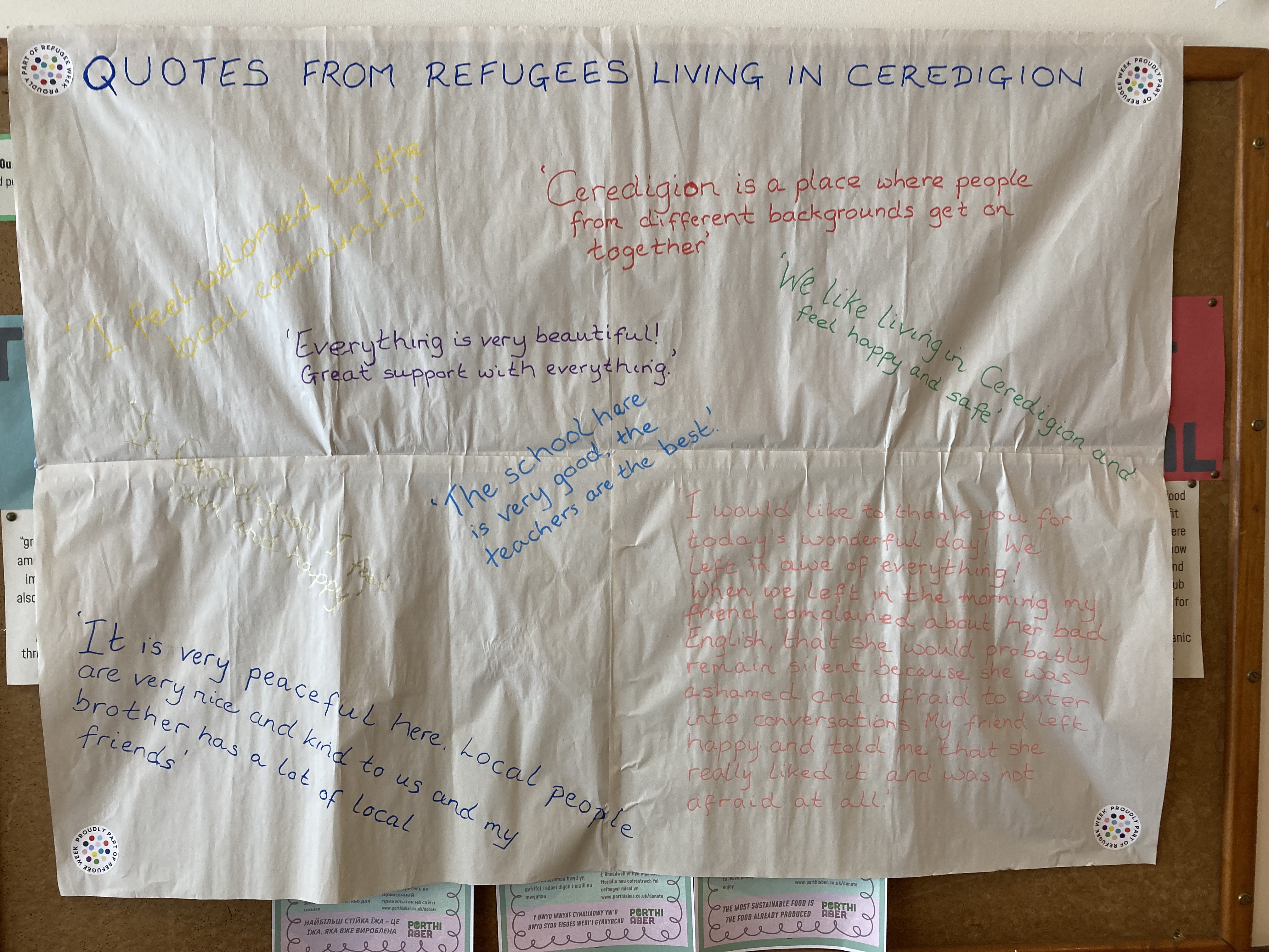 A display of handwritten quotes from refugees living in Ceredigion, sharing messages about welcome, support, safety and community as part of the Refugee Week celebration.